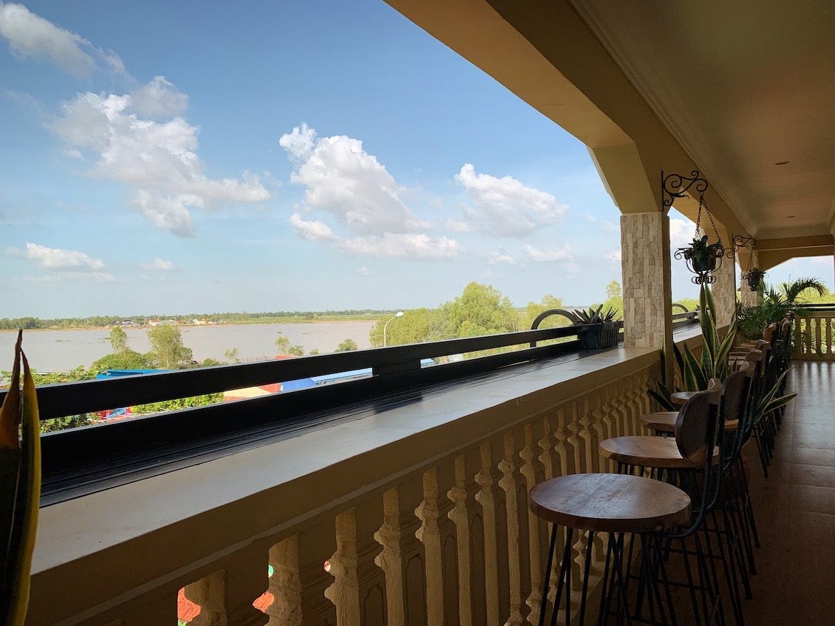 Rooftop terrace with tables overlooking the water